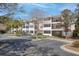 Inviting condo complex featuring well-maintained landscaping, ample parking, and screened in porches on each level at 1025 Riverland Woods Pl # 609, Charleston, SC 29412