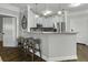 Open-concept kitchen featuring a breakfast bar with seating, gray cabinets, and stainless steel appliances at 1025 Riverland Woods Pl # 609, Charleston, SC 29412