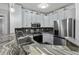 Modern kitchen featuring stainless steel appliances, granite countertops, and white cabinetry at 1025 Riverland Woods Pl # 609, Charleston, SC 29412