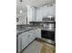 Modern kitchen with stainless steel appliances, gray cabinets, gray subway tile backsplash, and hardwood floors at 1025 Riverland Woods Pl # 609, Charleston, SC 29412