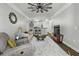 Open-concept living room with modern ceiling fan, plush rug, and view of the kitchen at 1025 Riverland Woods Pl # 609, Charleston, SC 29412