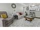Stylish living room with plush carpeting, comfortable seating, and an open view to the kitchen at 1025 Riverland Woods Pl # 609, Charleston, SC 29412
