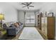 Spacious living room with hardwood floors, natural light, couch, cabinet, and ceiling fan at 1025 Riverland Woods Pl # 609, Charleston, SC 29412