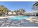 Community pool surrounded by palm trees and sun loungers at 1025 Riverland Woods Pl # 609, Charleston, SC 29412