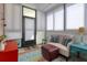 Bright sunroom with comfortable seating, colorful rug, and lots of natural light at 1025 Riverland Woods Pl # 609, Charleston, SC 29412