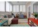 Bright sunroom with comfortable seating, colorful rug, and lots of natural light at 1025 Riverland Woods Pl # 609, Charleston, SC 29412