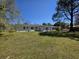 Expansive backyard with a lawn and a view of the home's patio and exterior at 1077 Harbor View Rd, Charleston, SC 29412