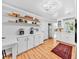 Bright kitchen featuring white cabinets, floating shelves, and stainless steel appliances at 1077 Harbor View Rd, Charleston, SC 29412