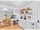 Bright kitchen and dining area with hardwood floors, floating shelves and coffee station at 1077 Harbor View Rd, Charleston, SC 29412