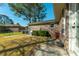 Backyard exterior featuring a brick home, manicured shrubbery, and patio space at 115 Clubhouse Rd, Summerville, SC 29483