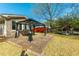 Charming backyard deck with a covered swing set, mature trees, and a lush lawn at 115 Clubhouse Rd, Summerville, SC 29483
