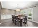 Bright and spacious dining area featuring a wooden table, stylish lighting, and ample natural light from large windows at 115 Clubhouse Rd, Summerville, SC 29483