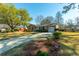 Classic single Gathering home boasts a brick facade, attached garage, and well-maintained lawn, offering suburban charm at 115 Clubhouse Rd, Summerville, SC 29483