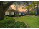Charming brick home featuring lush landscaping, a well-manicured lawn, and mature trees, creating a welcoming curb appeal at 115 Clubhouse Rd, Summerville, SC 29483