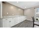 Bright room featuring custom storage with granite counters and stylish gray flooring at 115 Clubhouse Rd, Summerville, SC 29483