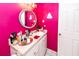 Stylish bathroom featuring a round mirror, vanity with sink, and bright magenta walls at 1158 Village Creek Ln # 3, Mount Pleasant, SC 29464