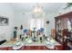 The dining room has a chandelier, wood table and chairs, and is decorated with flowers and vases at 1158 Village Creek Ln # 3, Mount Pleasant, SC 29464