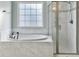 Bathroom featuring large garden tub and tiled glass shower at 116 Rouen Ln, Summerville, SC 29486