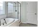 Clean bathroom with a glass enclosed shower and a large soaking tub at 116 Rouen Ln, Summerville, SC 29486