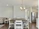 Dining area features a wooden table with white chairs, with a view into the kitchen at 116 Rouen Ln, Summerville, SC 29486