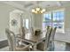 Dining room with table, chairs, chandelier, and large windows at 116 Rouen Ln, Summerville, SC 29486
