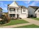 Charming two-story home featuring a covered porch, attached garage, and well-manicured lawn at 116 Rouen Ln, Summerville, SC 29486