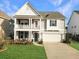 Charming two-story home featuring a covered porch, attached garage, and well-manicured lawn at 116 Rouen Ln, Summerville, SC 29486