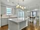 Kitchen with light grey cabinets, quartz countertops, island and hardwood floors at 116 Rouen Ln, Summerville, SC 29486