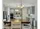Open concept with the dining table in front of a bright kitchen with stainless steel appliances at 116 Rouen Ln, Summerville, SC 29486