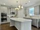 Spacious kitchen with gray cabinets, stainless steel appliances, and large island at 116 Rouen Ln, Summerville, SC 29486