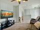 A well-lit, carpeted living room area with a television and ceiling fan at 116 Rouen Ln, Summerville, SC 29486