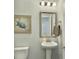 Traditional powder room with pedestal sink, decorative mirror, lighting, and artwork at 116 Rouen Ln, Summerville, SC 29486