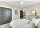 Cozy bedroom with modern gray doors, ensuite access, and warm neutral tones at 1429 Lettered Olive Ln, Mount Pleasant, SC 29464