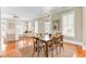 Elegant dining area with hardwood floors, stylish lighting, and seamless access to the living room for easy flow at 1429 Lettered Olive Ln, Mount Pleasant, SC 29464