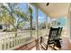 Relaxing front porch with wooden flooring, classic rocking chairs, and views of the neighborhood at 1429 Lettered Olive Ln, Mount Pleasant, SC 29464