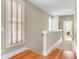 Upstairs hallway with light walls, hardwood floors, and natural light at 1429 Lettered Olive Ln, Mount Pleasant, SC 29464