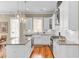 Kitchen with stainless steel appliances, white cabinetry, and hardwood flooring at 1429 Lettered Olive Ln, Mount Pleasant, SC 29464