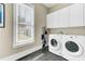 Laundry room with white washer and dryer, and storage cabinets at 1429 Lettered Olive Ln, Mount Pleasant, SC 29464