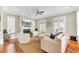 Cozy living room with a fireplace, hardwood floors, and ample natural light with comfortable seating at 1429 Lettered Olive Ln, Mount Pleasant, SC 29464