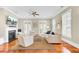 Bright living room featuring hardwood floors, fireplace, ceiling fan, and lots of natural light at 1429 Lettered Olive Ln, Mount Pleasant, SC 29464