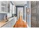 Pantry with granite countertops, glass cabinets, and blue walls at 1429 Lettered Olive Ln, Mount Pleasant, SC 29464