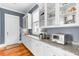 Pantry with granite countertops, glass cabinets, and white trim at 1429 Lettered Olive Ln, Mount Pleasant, SC 29464