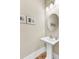 Powder room with pedestal sink, wood flooring, and neutral walls at 1429 Lettered Olive Ln, Mount Pleasant, SC 29464