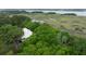 Aerial view of home surrounded by green trees near the marsh at 1456 Mcpherson Lndg, Johns Island, SC 29455