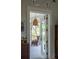 View of covered balcony from bedroom, complete with hanging lights and wicker chair at 1456 Mcpherson Lndg, Johns Island, SC 29455