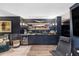 Dark, finished basement featuring a bar, a TV, and a comfortable seating area at 1456 Mcpherson Lndg, Johns Island, SC 29455