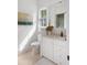 Clean and modern bathroom with white cabinets, granite counters, and decorative artwork at 1456 Mcpherson Lndg, Johns Island, SC 29455