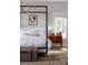Bright bedroom with poster bed, wood floors, chest, and natural light at 1456 Mcpherson Lndg, Johns Island, SC 29455