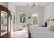 Bedroom with door to balcony, natural light, and hardwood floors at 1456 Mcpherson Lndg, Johns Island, SC 29455