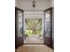 Inviting entrance featuring double doors opening to a porch with serene views of a majestic oak tree and lush greenery at 1456 Mcpherson Lndg, Johns Island, SC 29455